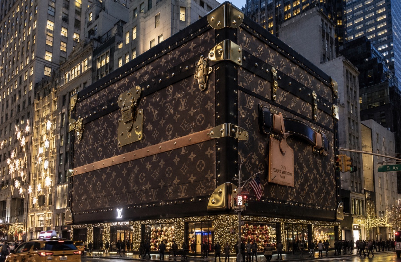 Louis Vuitton flagship on Fifth Avenue wrapped as a giant monogrammed trunk with gold hardware and holiday lights